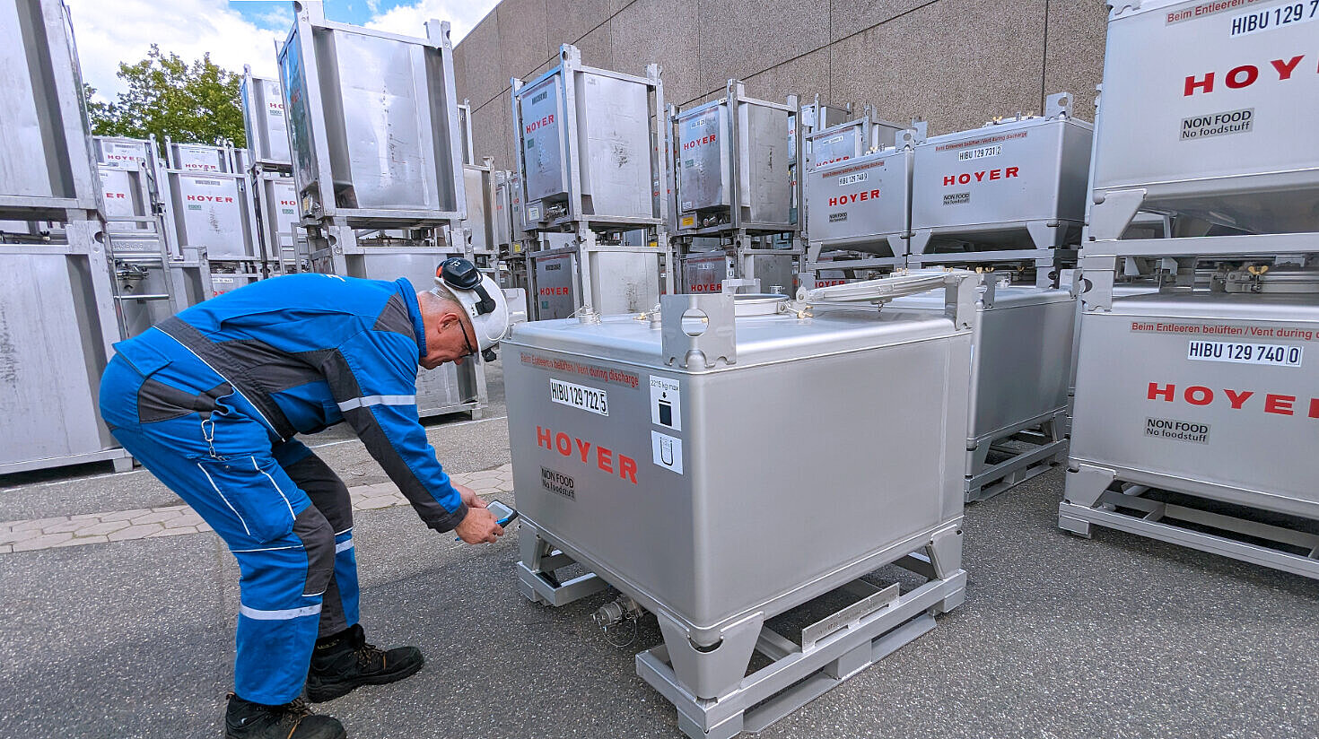 employee stands in front of a Meter Cube and scans it